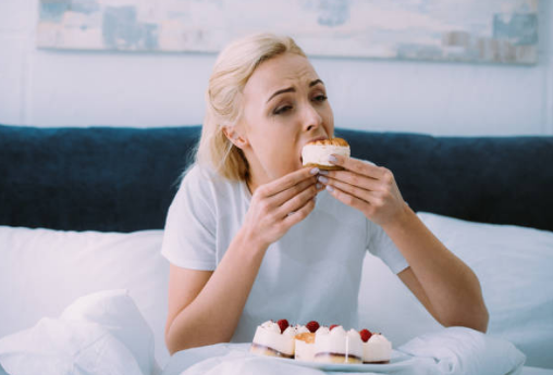 woman eating sweets at night