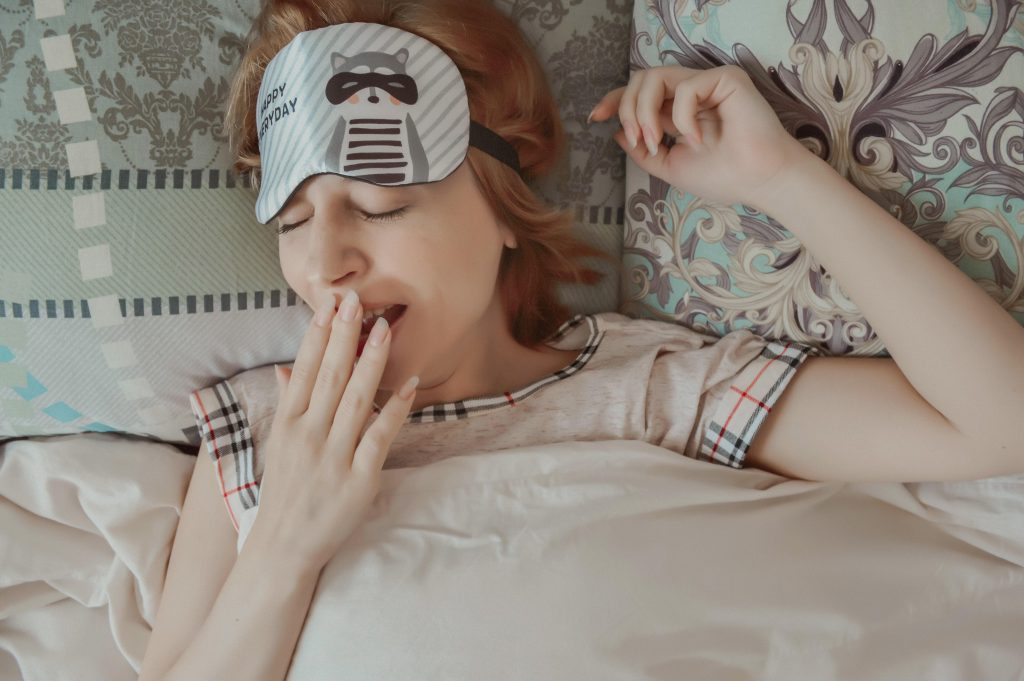 Midlife woman yawning and relaxing, getting ready to sleep to support hormone balance and better sleep during perimenopause