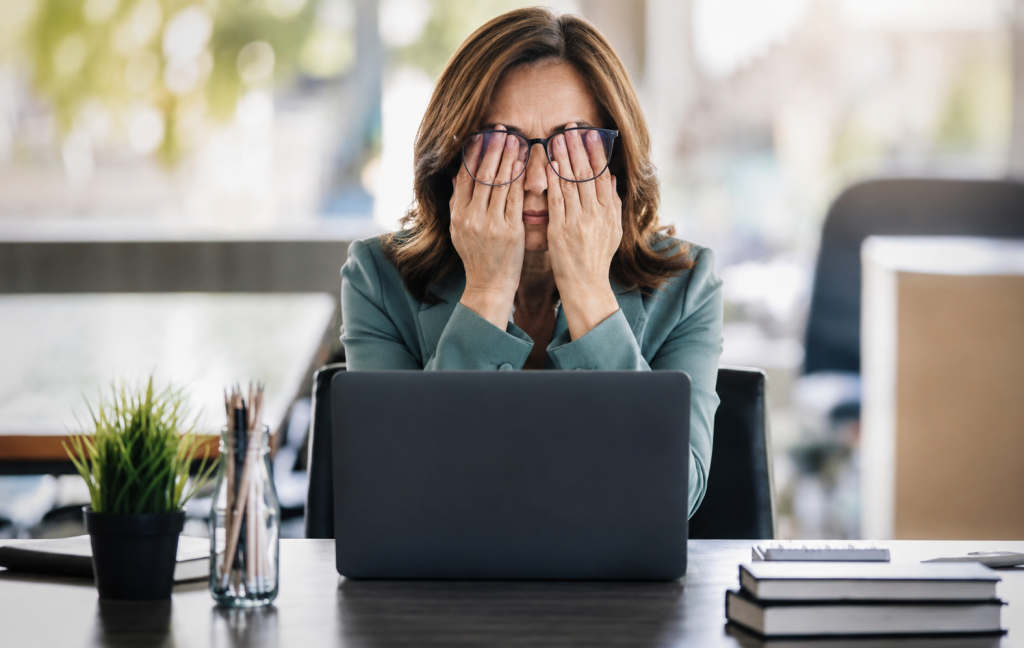 Stressed midlife woman trying to work and frustrated about not being able to lose weight.